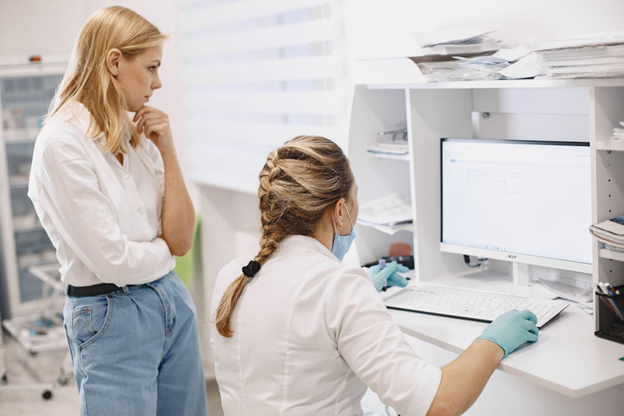 Medical professionals reviewing patient data on a computer in a clinical setting